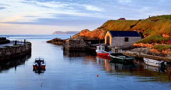 Sunset at the blue hour over the quaint and wild Ballintoy Harbour