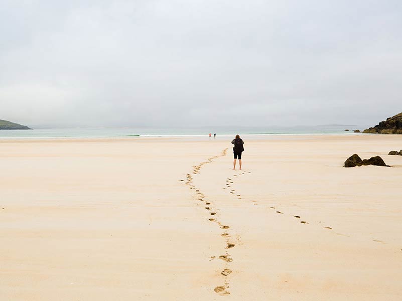 footprints on a misty beach
